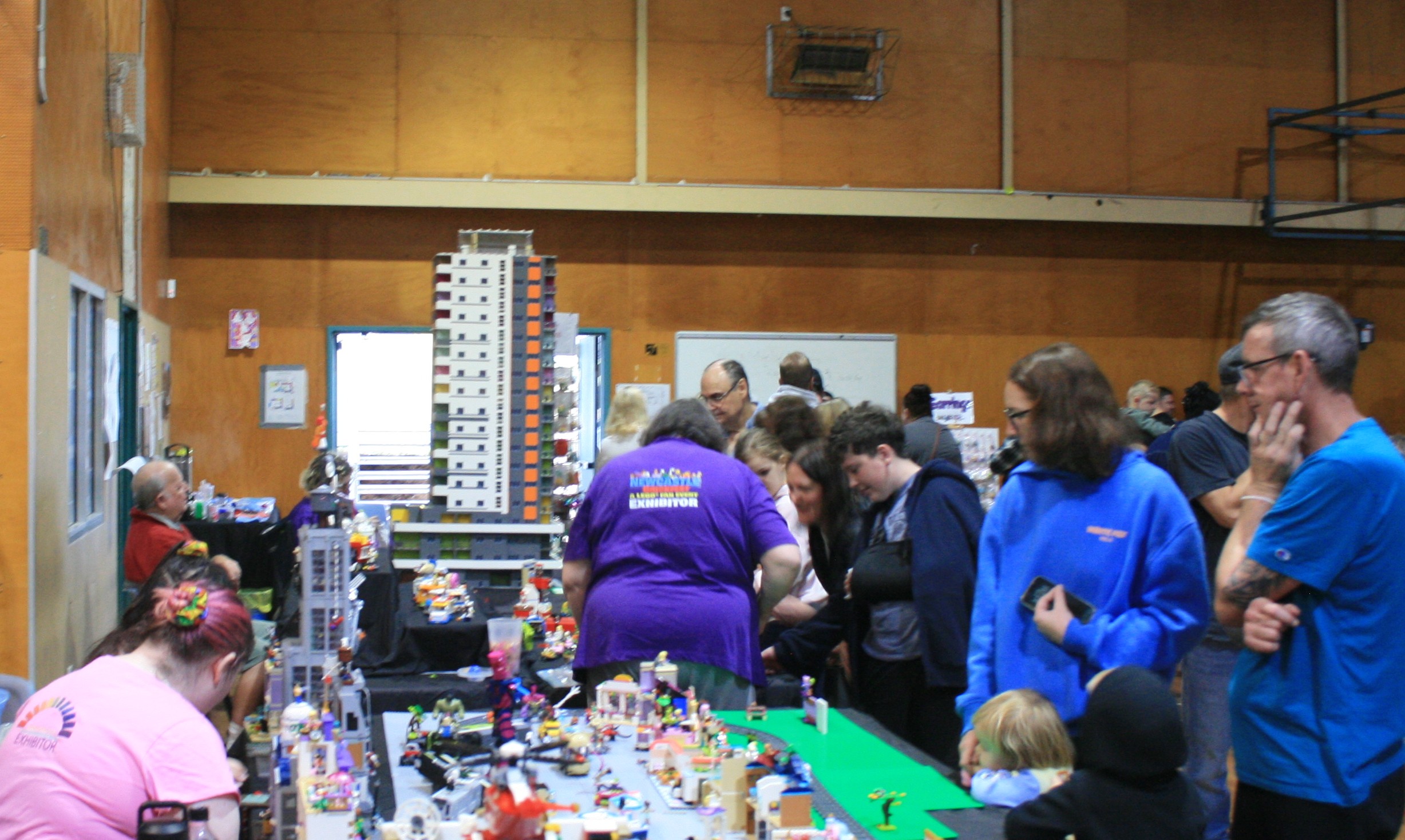 Rainbow Bricks community members smiling and talking to members of the public.