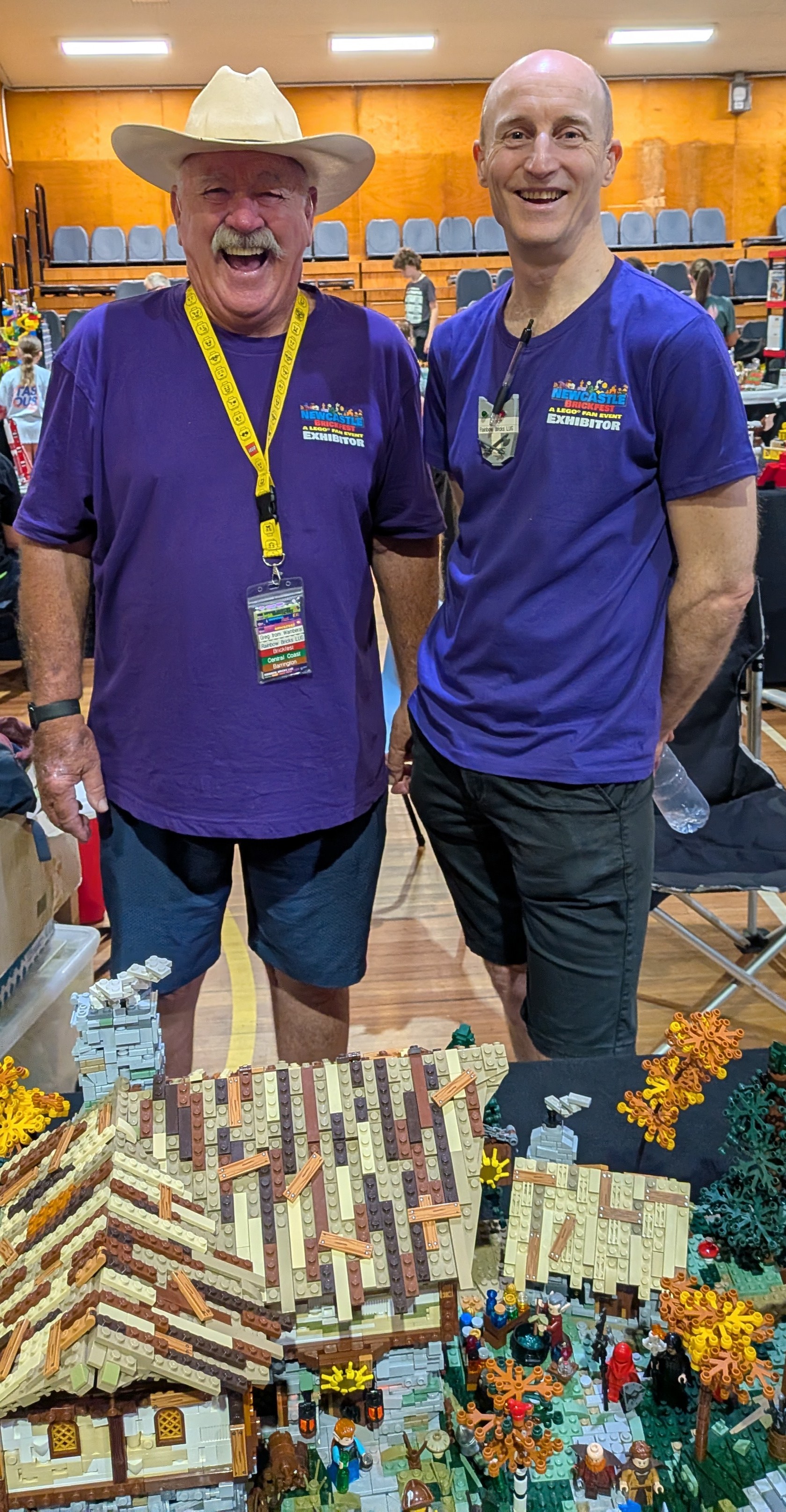 Rainbow Bricks builders wearing branded club shirts collaborating at a public fan event