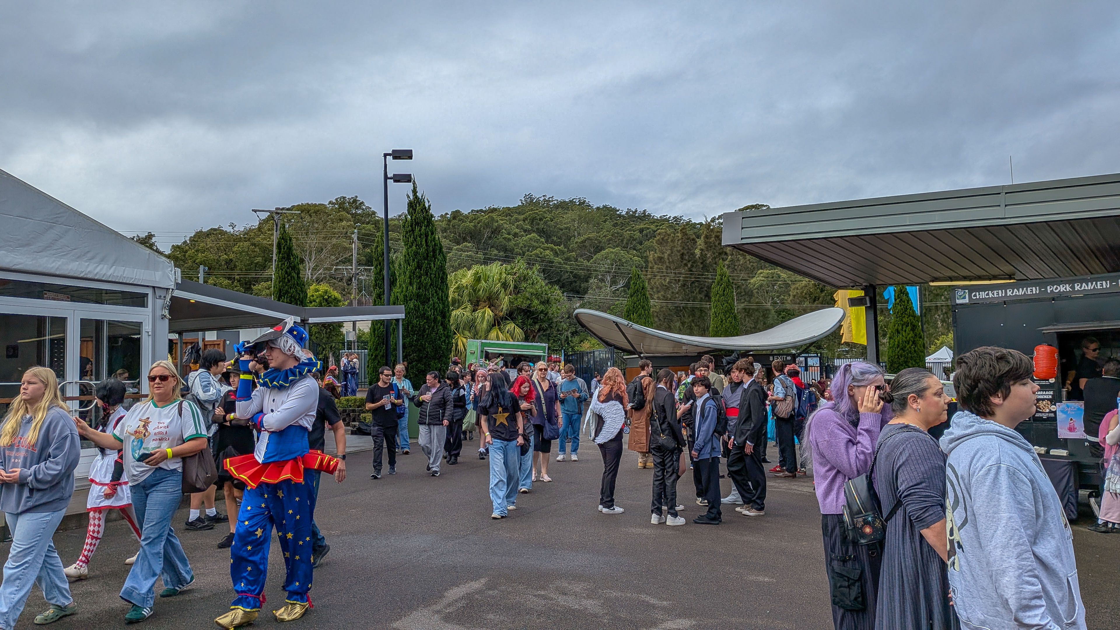 Crowds and cosplayers gathering outside the venue despite the wet weather