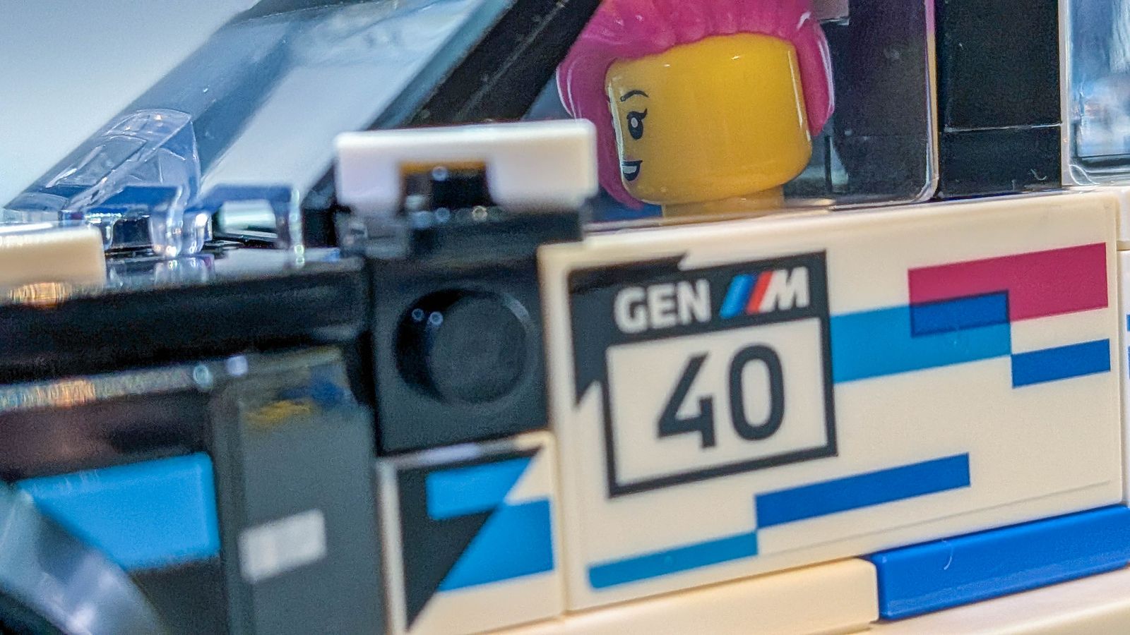 Close-up of the printed GEN M 40 panel on the side of the car