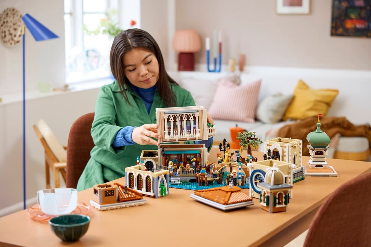 A builder putting the Venetian Neighbourhood sections together