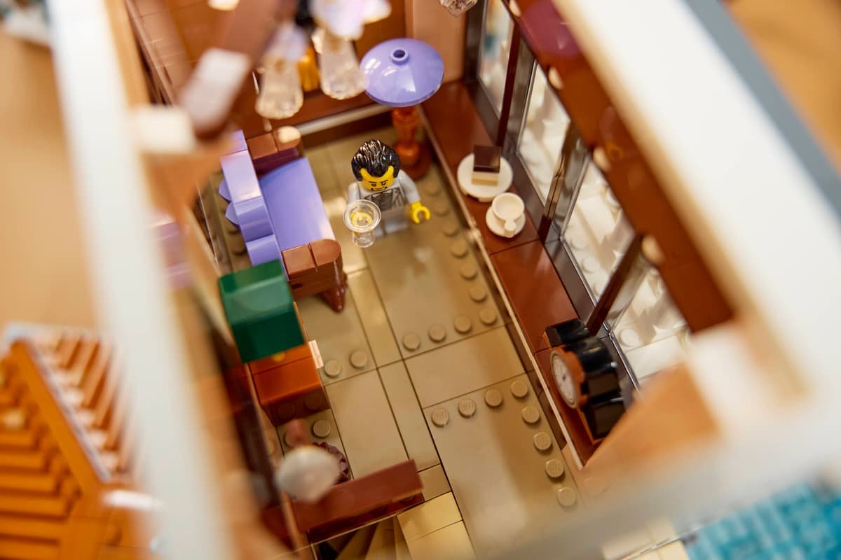 Looking down into the villa lounge with a minifigure holding a glass