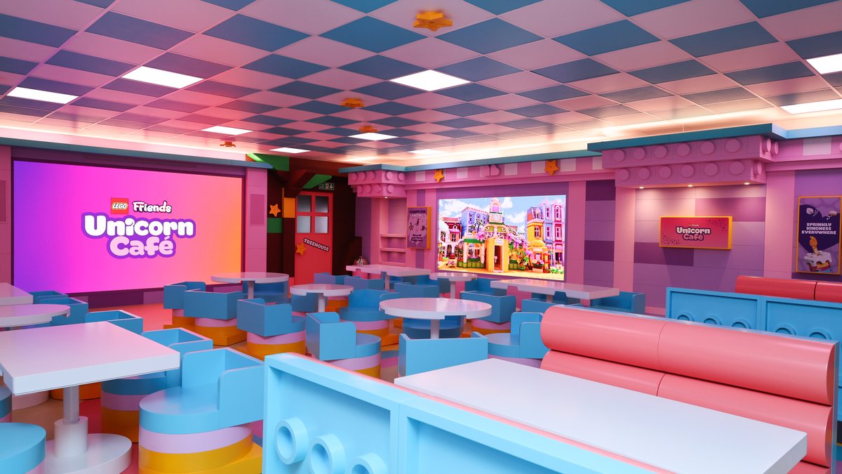 Inside the LEGO Friends Unicorn Café with giant LEGO brick booths and a rainbow floor